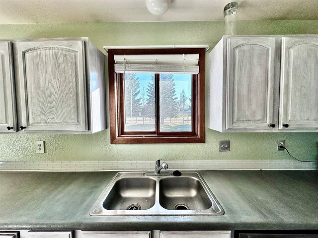 kitchen featuring sink and white cabinets