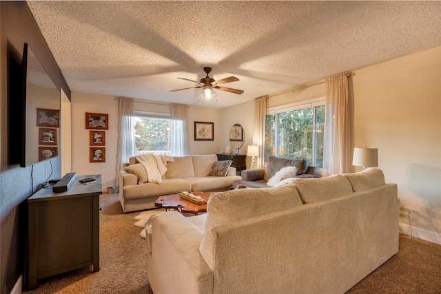 carpeted living room featuring ceiling fan, a wealth of natural light, and a textured ceiling