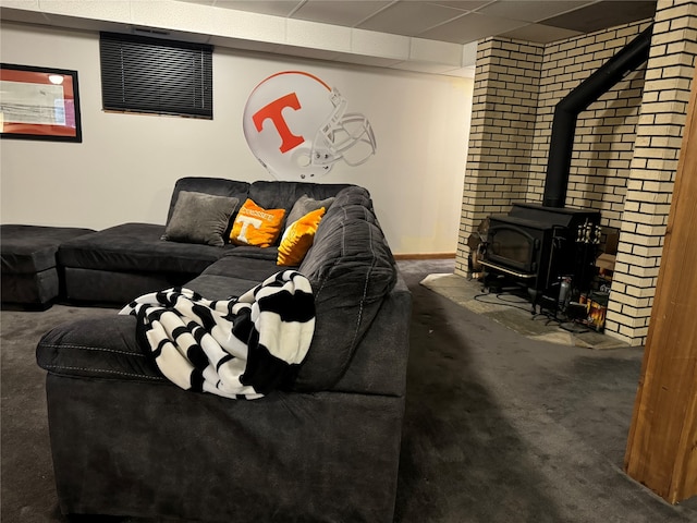 carpeted living room with a wood stove