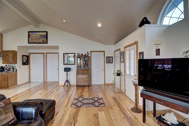 living room featuring beam ceiling, high vaulted ceiling, and light hardwood / wood-style flooring