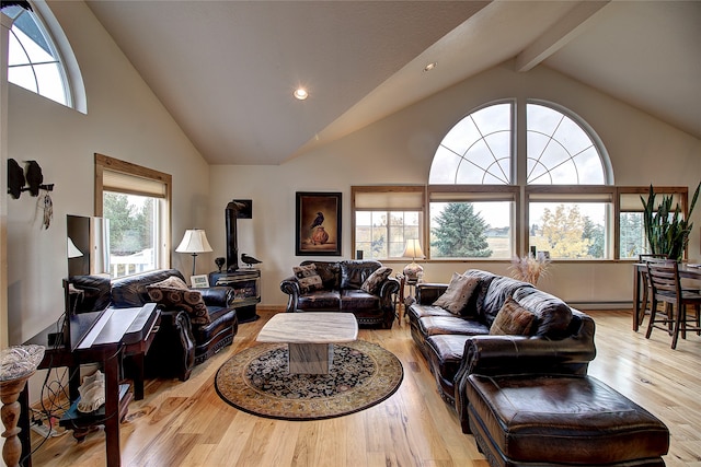 living room with beamed ceiling, plenty of natural light, high vaulted ceiling, and light hardwood / wood-style flooring