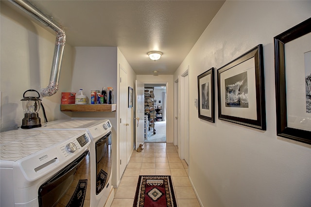 laundry room with independent washer and dryer, a textured ceiling, and light tile patterned floors