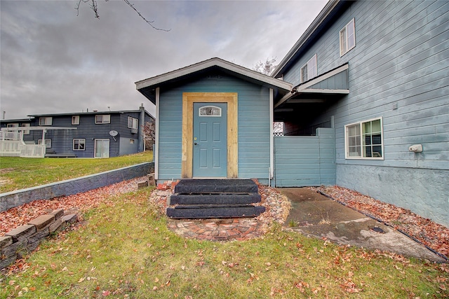 view of exterior entry with a lawn