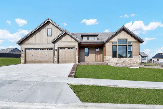 view of front of property with a garage and a front yard