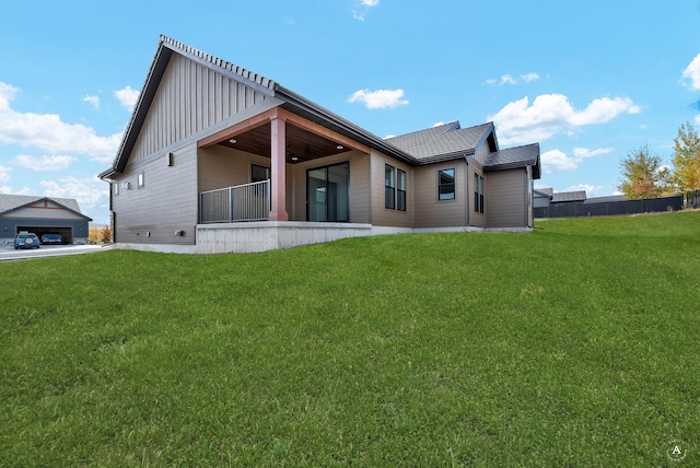 rear view of house featuring a yard