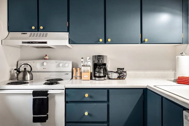 45 Alder Way Unit 3C, Whitefish, MT 59937 - kitchen with white electric stove, under cabinet range hood, light countertops, and blue cabinetry