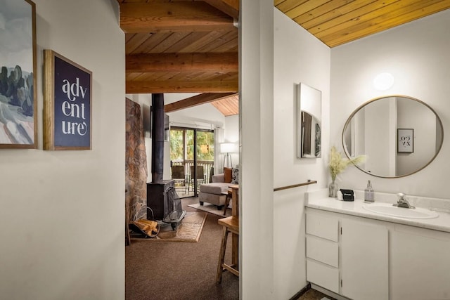 45 Alder Way Unit 3C, Whitefish, MT 59937 - bathroom with wooden ceiling, a wood stove, and vanity