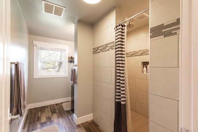 bathroom featuring hardwood / wood-style floors and a shower with curtain