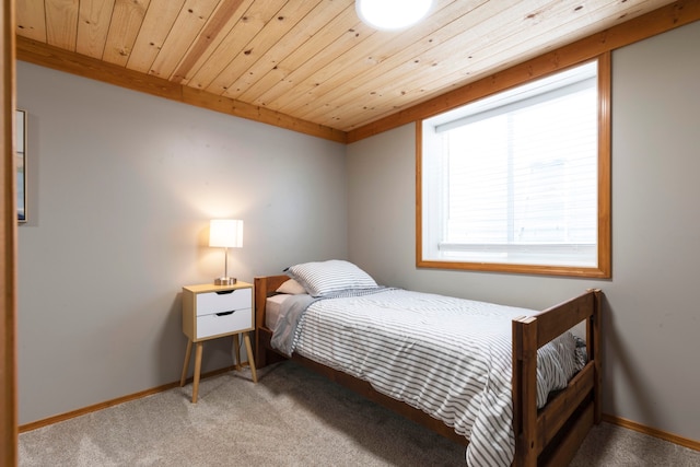 carpeted bedroom with wood ceiling