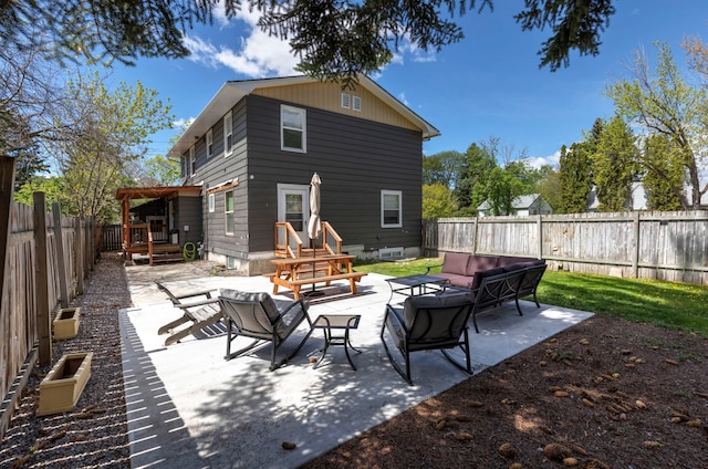 back of house featuring a patio area and outdoor lounge area