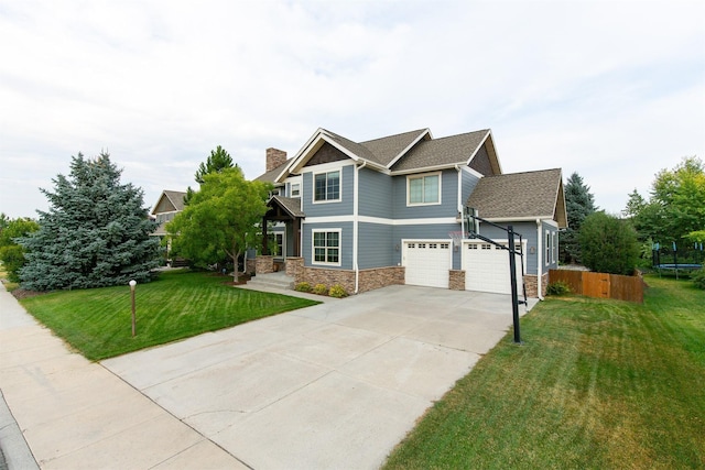 craftsman-style home featuring a trampoline, a front lawn, and a garage