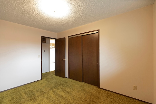 unfurnished bedroom with a closet, carpet flooring, and a textured ceiling