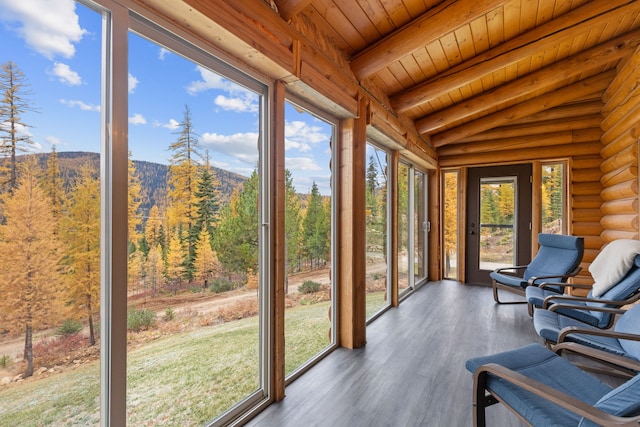 2197 W Tower Rd, Saltese, MT 59867 - sunroom / solarium with rustic walls, wood finished floors, beam ceiling, wood ceiling, and a mountain view