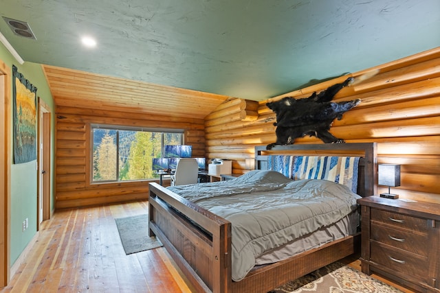 2197 W Tower Rd, Saltese, MT 59867 - bedroom with rustic walls, light wood-type flooring, and lofted ceiling