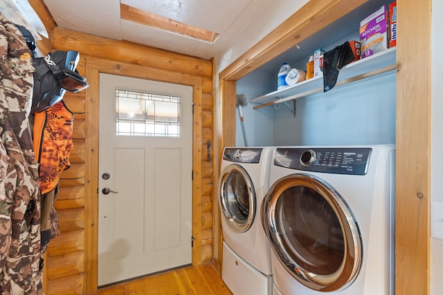 2197 W Tower Rd, Saltese, MT 59867 - washroom featuring log walls, separate washer and dryer, and light wood-type flooring