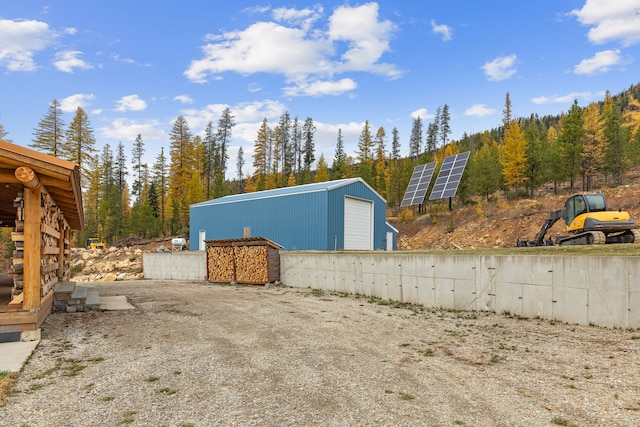 2197 W Tower Rd, Saltese, MT 59867 - view of outbuilding featuring solar panels and a view of trees