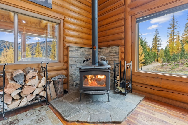 2197 W Tower Rd, Saltese, MT 59867 - detailed view of a wood stove, wood finished floors, and rustic walls