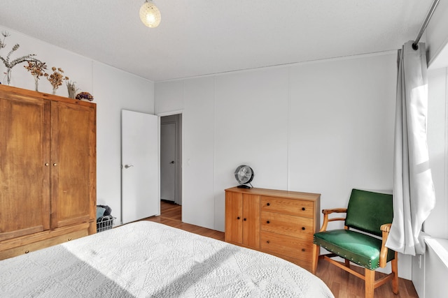 bedroom with dark wood-type flooring