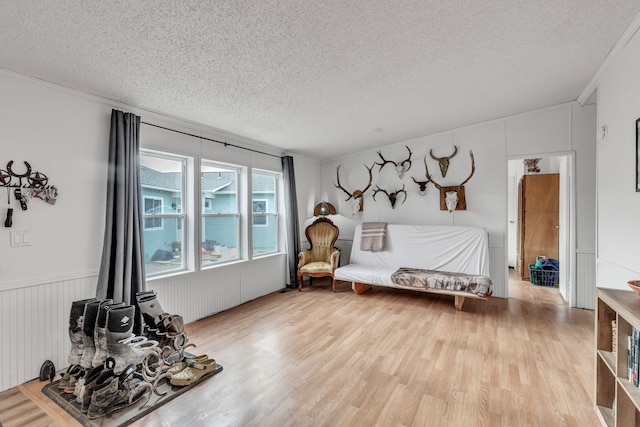 sitting room with a textured ceiling and wood-type flooring