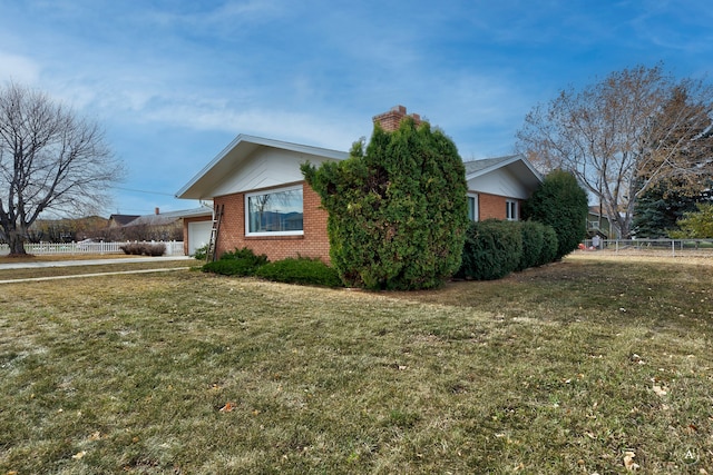 view of home's exterior with a lawn