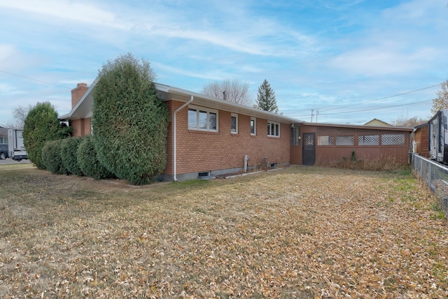 back of property featuring a lawn