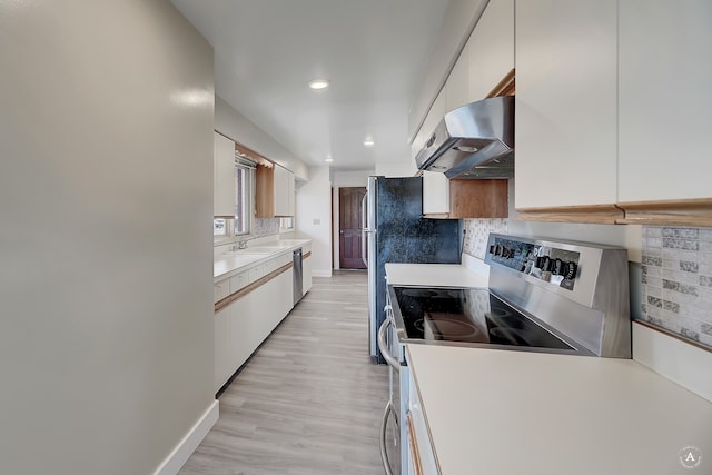 kitchen featuring sink, electric range, white cabinetry, light hardwood / wood-style flooring, and ventilation hood