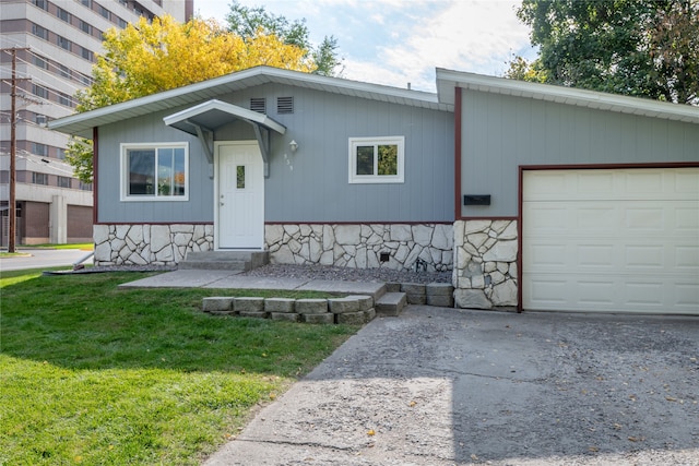 view of front of home with a front yard and a garage