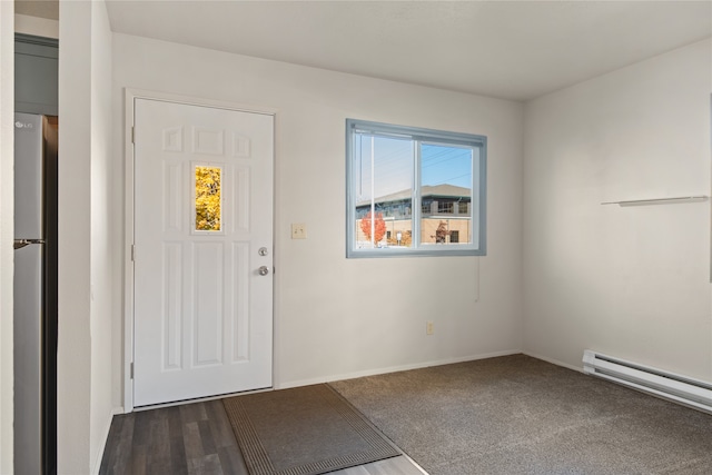 foyer with a baseboard radiator and dark hardwood / wood-style flooring