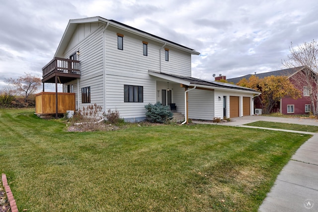 view of front facade with a balcony, a garage, and a front lawn