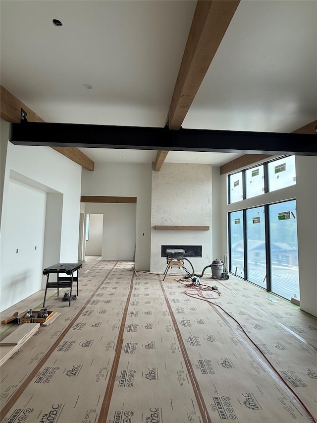 448 Highline Ct, Whitefish, MT 59937 - unfurnished living room with beamed ceiling and a large fireplace