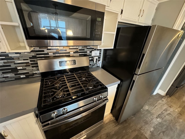 kitchen featuring backsplash, appliances with stainless steel finishes, dark hardwood / wood-style floors, and white cabinets