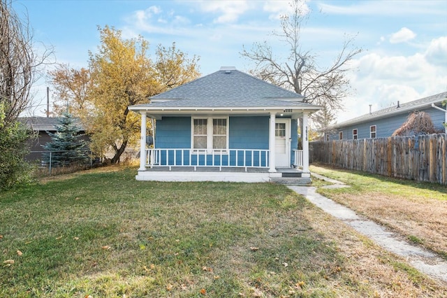 bungalow-style home featuring a front yard and covered porch