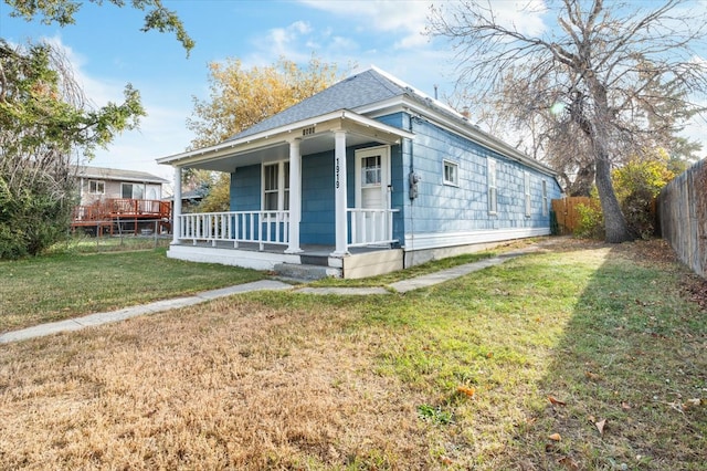 bungalow-style house with a deck and a front yard