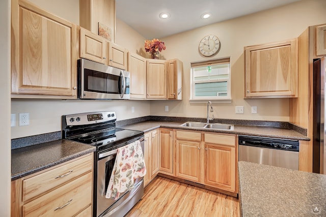 kitchen with light brown cabinets, light hardwood / wood-style floors, sink, and appliances with stainless steel finishes