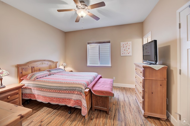 bedroom with wood-type flooring and ceiling fan