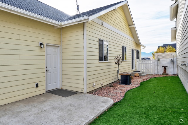 view of home's exterior with central air condition unit, a lawn, and a patio area