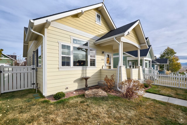 view of front of home featuring a front yard and covered porch