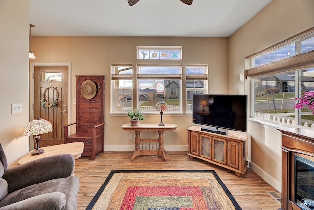 living room featuring light wood-type flooring and ceiling fan