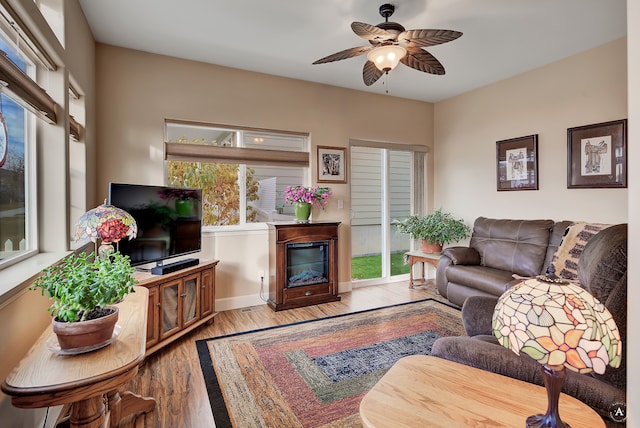 living room featuring ceiling fan and light wood-type flooring