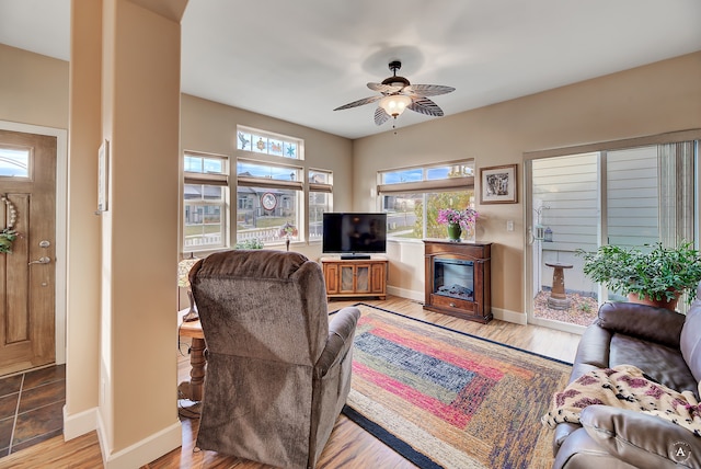 living room featuring light hardwood / wood-style floors and ceiling fan