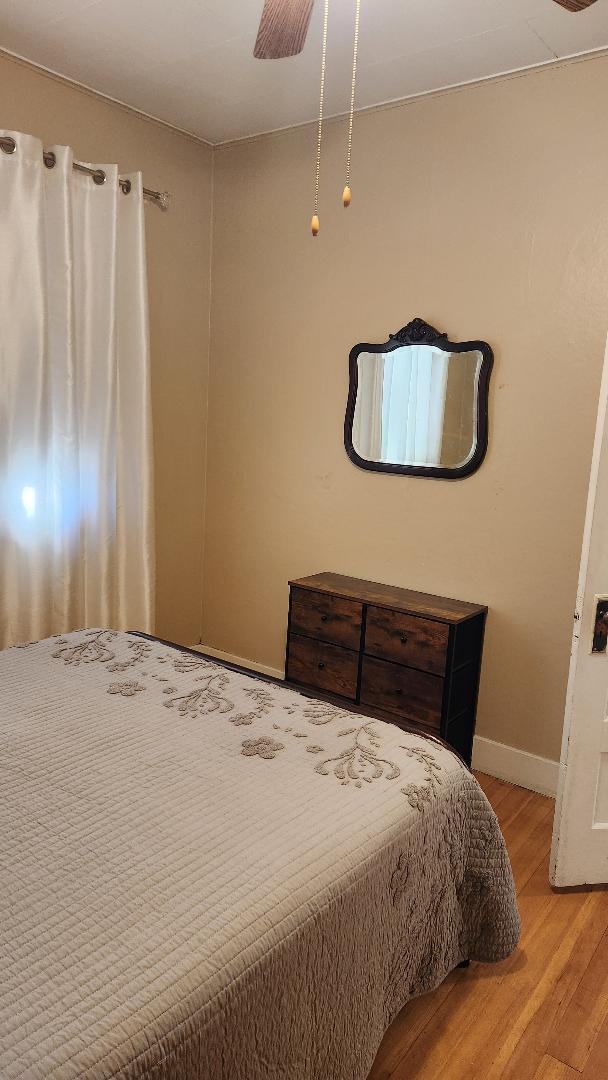 bedroom with ceiling fan and light hardwood / wood-style floors