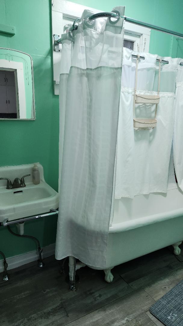 bathroom with hardwood / wood-style floors and shower / tub combo