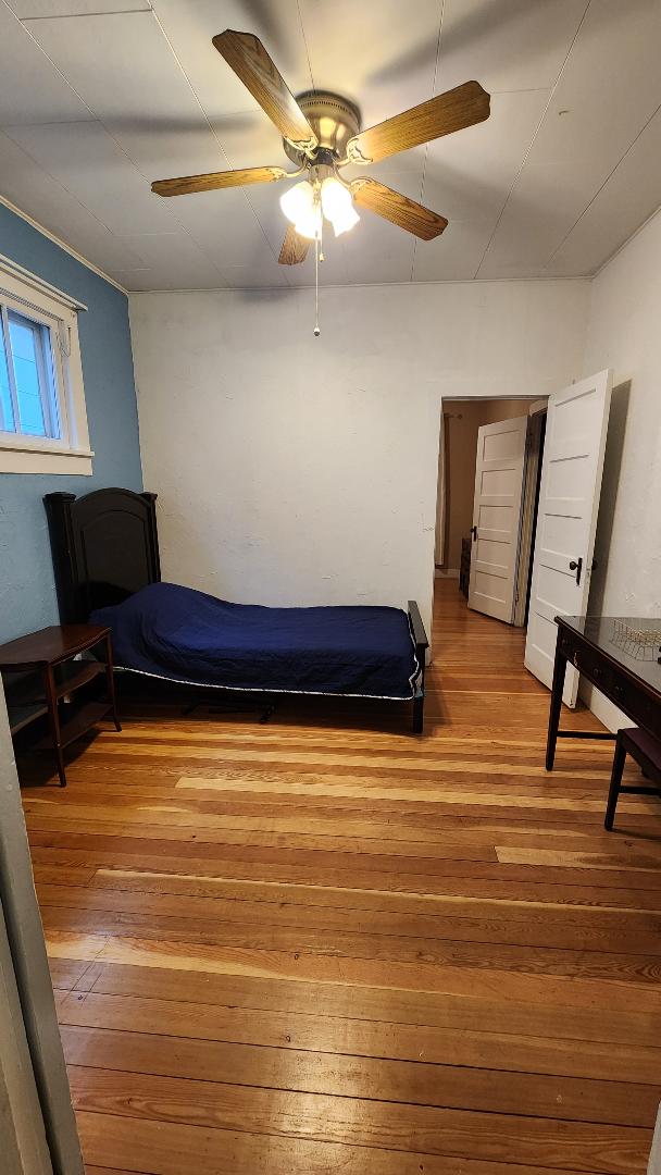 bedroom featuring hardwood / wood-style floors and ceiling fan