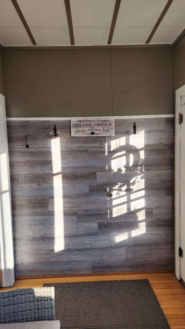 interior details with hardwood / wood-style floors and wood walls