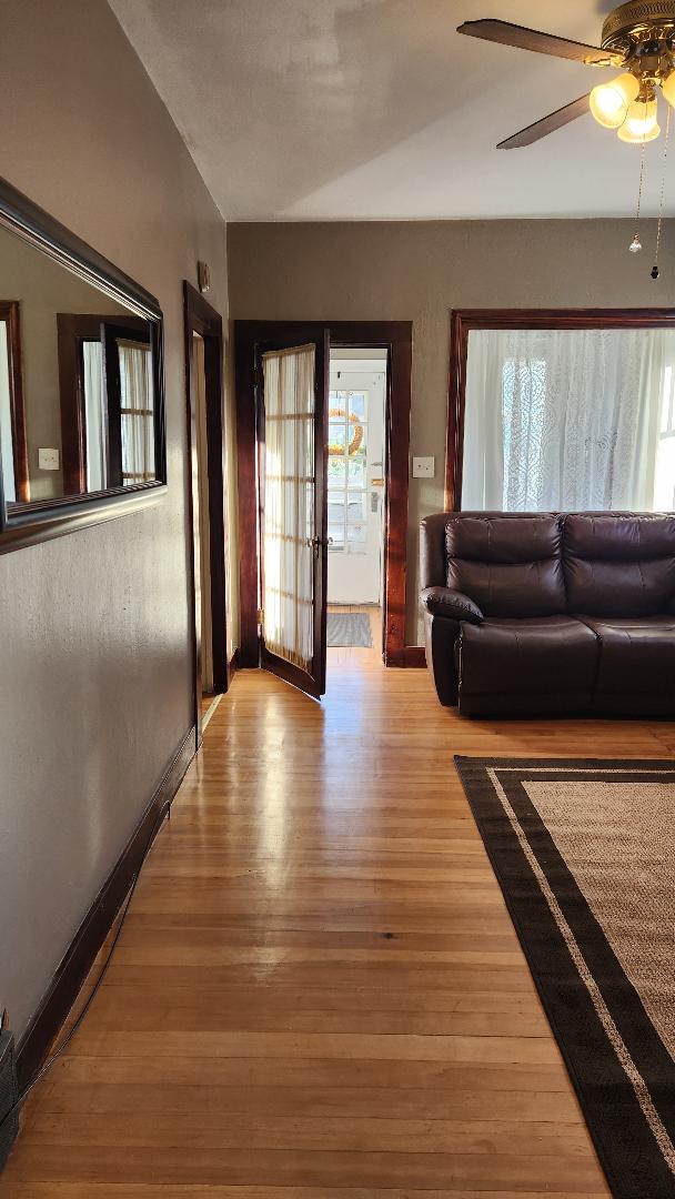 unfurnished living room featuring light hardwood / wood-style flooring, a wealth of natural light, and ceiling fan