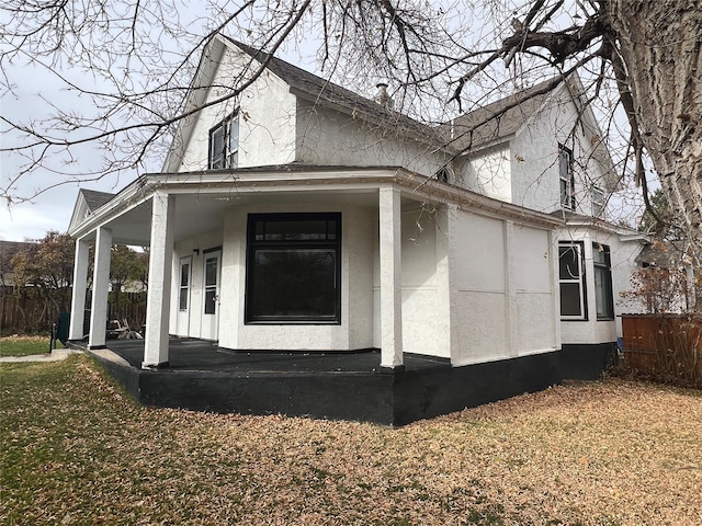 view of side of property featuring covered porch