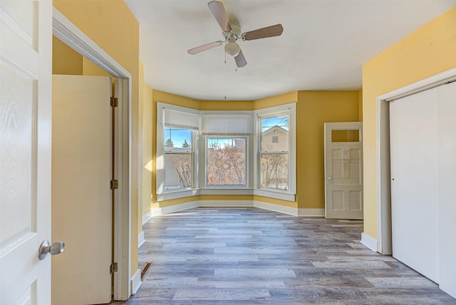 420 Knight St, Helena, MT 59601 - unfurnished bedroom featuring wood finished floors, baseboards, a ceiling fan, and a closet