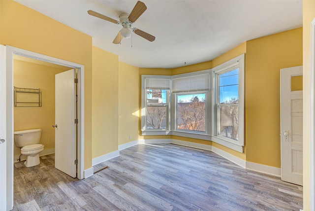 420 Knight St, Helena, MT 59601 - spare room featuring wood finished floors, a ceiling fan, and baseboards