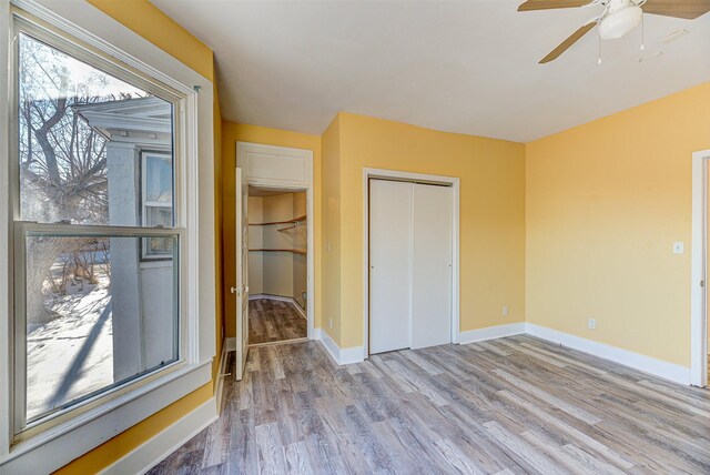 420 Knight St, Helena, MT 59601 - unfurnished bedroom with wood finished floors, a closet, baseboards, and a ceiling fan