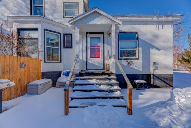 420 Knight St, Helena, MT 59601 - snow covered property entrance featuring stucco siding and fence